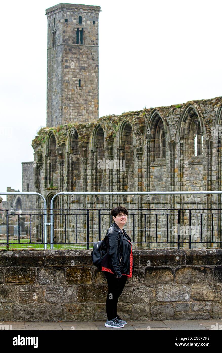 St Andrews, Fife, Scotland, UK. 3rd July, 2021. UK Weather: A cool misty day across North East Scotland with temperatures reaching 15°C. An American female tourist takes the day out to be photographed while sightseeing at the 1400`s Cathedral ruins in St Andrews. Credit: Dundee Photographics/Alamy Live News Stock Photo